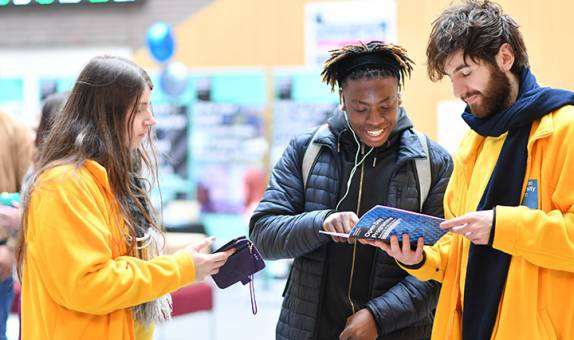 An applicant talking to two student ambassadors at an open day